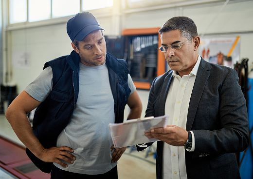 mid-adult-manager-car-mechanic-analyzing-data-while-going-trough-reports-auto-repair-shop - Copy 1