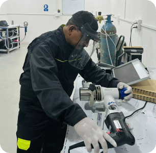 image 1 Trainee in PPE preparing an orbital weld head on stainless pipe at the Awilli training academy