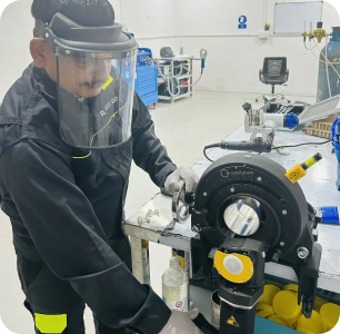 image 2 Trainee with face shield operating an orbital pipe facing machine during welding training