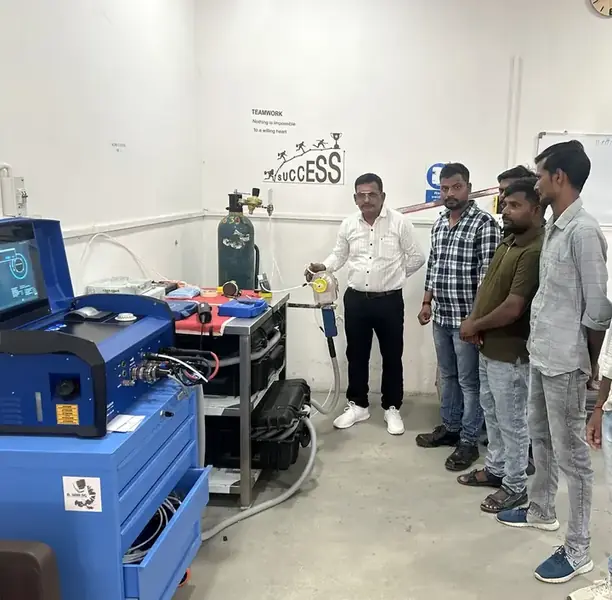 Orbital welding instructor and trainees, Ahmedabad Orbital welding instructor with a group of trainees beside the orbital welding equipment at the Awilli academy in Ahmedabad, India