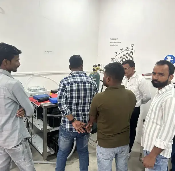Orbital welding training group, Ahmedabad Trainees gathered around an orbital welding machine during a practical session at the Awilli training academy, Ahmedabad